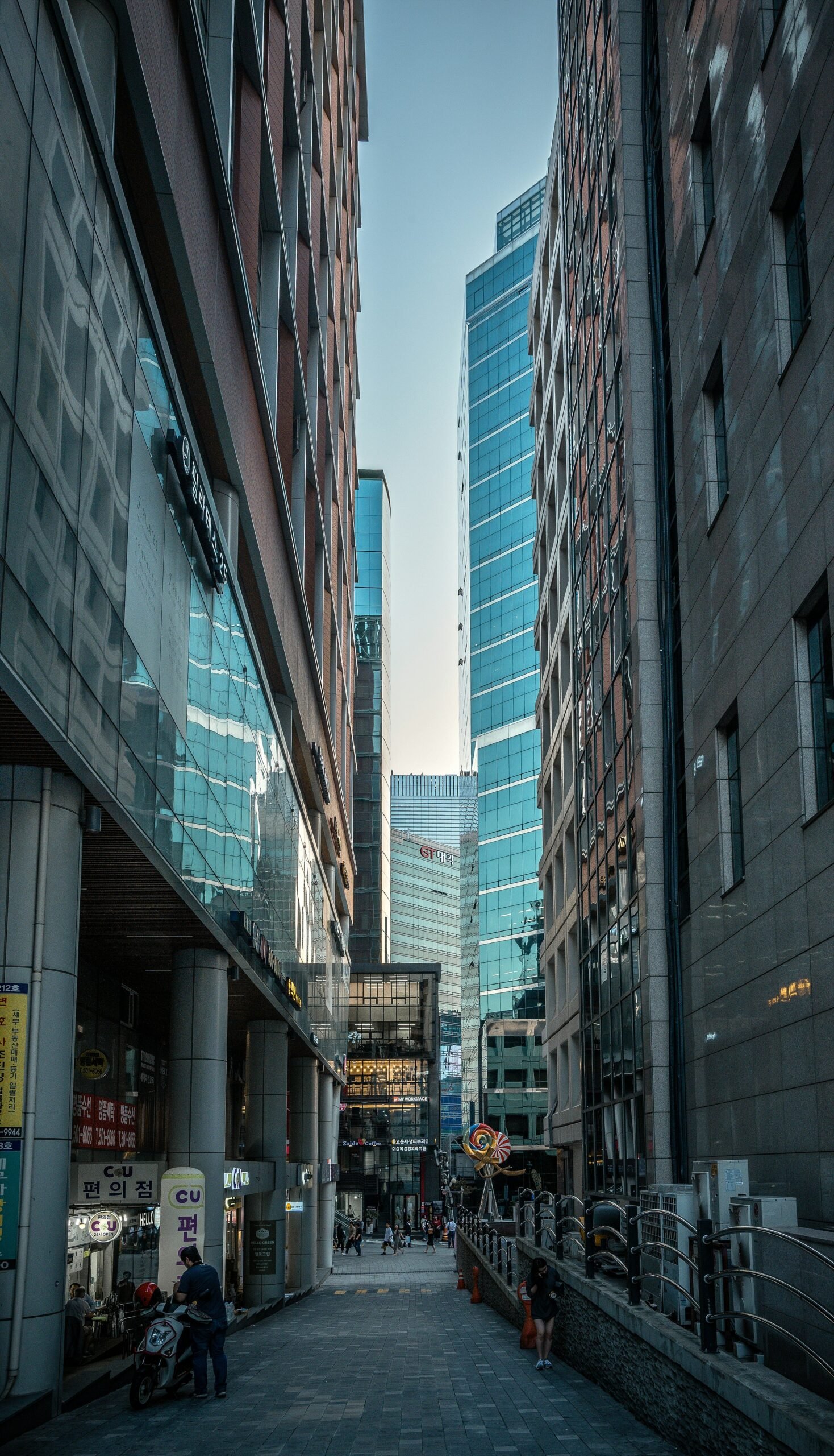 person walking on pathway between buildings