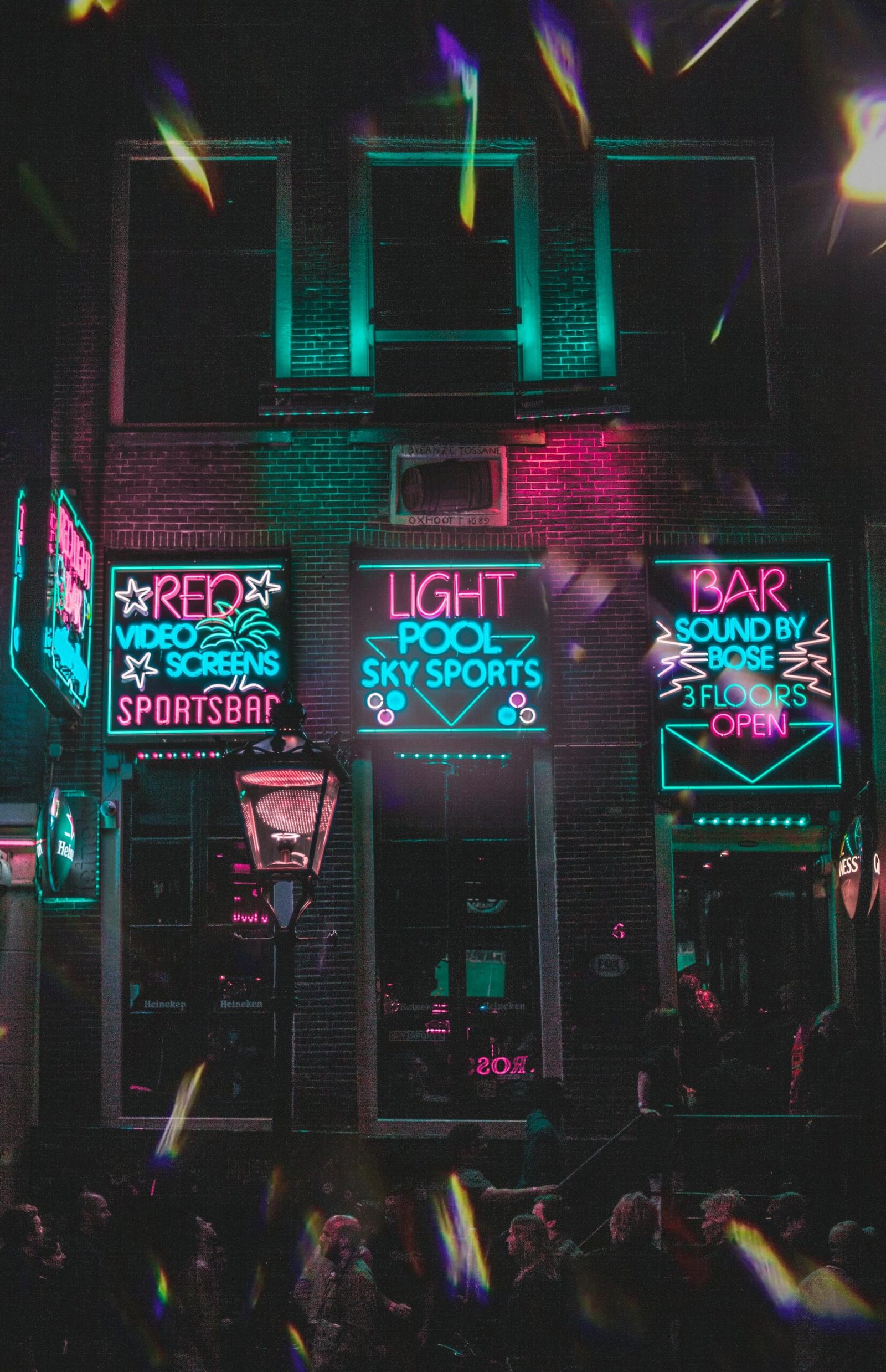 Dynamic neon-lit bar facade in Amsterdam's vibrant nightlife district.