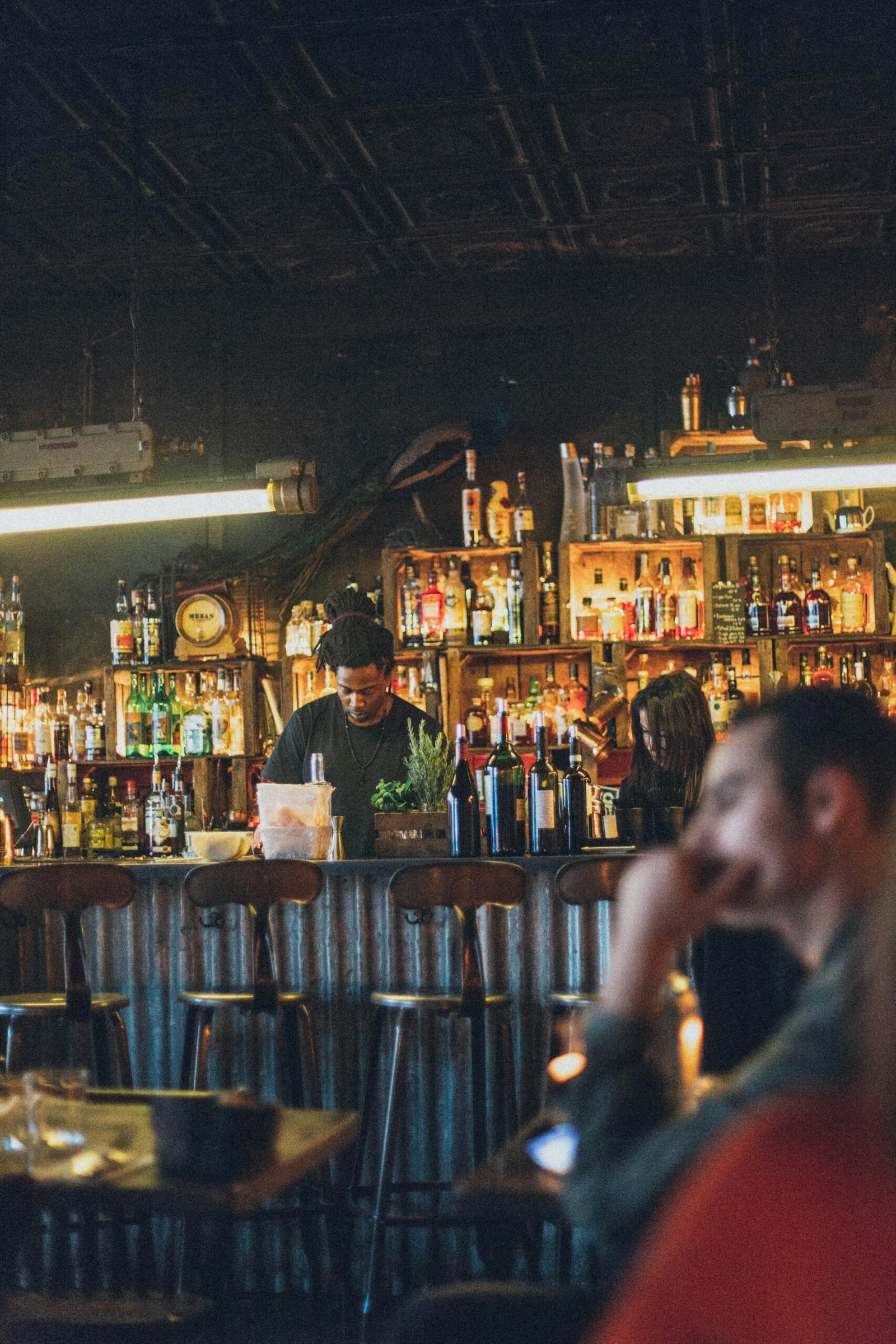 Atmospheric bar scene with diverse patrons enjoying drinks and lively ambiance.